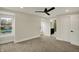 Spacious bedroom featuring plush carpeting, a modern ceiling fan, and ensuite bathroom access at 2103 Postmaster Ln, Greenfield, IN 46140
