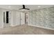 Spacious bedroom with elegant wallpaper, large windows, plush carpeting, and access to an en-suite bathroom at 2103 Postmaster Ln, Greenfield, IN 46140
