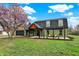 Charming home with manicured lawn, blooming tree, dark roof, and lovely curb appeal at 2103 Postmaster Ln, Greenfield, IN 46140