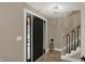 View of the front door, entry way, stairs, and modern light fixture at 2103 Postmaster Ln, Greenfield, IN 46140