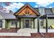 Charming home featuring a striking entryway with a custom wood-framed portico and a decorative front door at 2103 Postmaster Ln, Greenfield, IN 46140