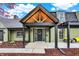 Charming home featuring a black front door with a wreath and a covered entrance with exposed wood beams at 2103 Postmaster Ln, Greenfield, IN 46140