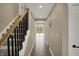 Well-lit hallway with hardwood floors leading to the backyard deck at 2103 Postmaster Ln, Greenfield, IN 46140
