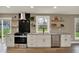 Well-lit kitchen with white cabinets, granite countertops, stainless steel appliances, and open shelving at 2103 Postmaster Ln, Greenfield, IN 46140