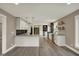 Bright kitchen with white cabinets, granite countertops, hardwood floors, and modern stainless steel appliances at 2103 Postmaster Ln, Greenfield, IN 46140