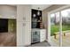 View of the kitchenette with wet bar, white cabinets, hardwood floors, and sliding glass doors at 2103 Postmaster Ln, Greenfield, IN 46140