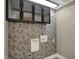 Well-designed laundry room with floral wallpaper and modern black cabinets providing ample storage space at 2103 Postmaster Ln, Greenfield, IN 46140
