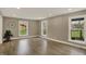 Spacious living room with hardwood floors, neutral walls, and bright windows overlooking the yard at 2103 Postmaster Ln, Greenfield, IN 46140