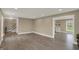 Open-concept living space boasting wood-look floors, neutral paint, and a staircase leading to the upper level at 2103 Postmaster Ln, Greenfield, IN 46140