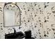 Stylish powder room with a black vessel sink, unique floral wallpaper, and elegant lighting at 2103 Postmaster Ln, Greenfield, IN 46140