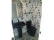 Chic powder room boasting modern fixtures, a black pedestal sink, and eye-catching patterned floors at 2103 Postmaster Ln, Greenfield, IN 46140
