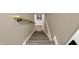 Staircase with a wooden banister and a Star Wars poster at 2103 Postmaster Ln, Greenfield, IN 46140