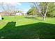 Expansive backyard with lush green grass, mature trees, and a storage shed at 2206 Tansel Crossing Cir, Indianapolis, IN 46234