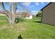 View of a large, grassy backyard with mature trees and a storage shed at 2206 Tansel Crossing Cir, Indianapolis, IN 46234