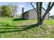 Spacious backyard with green grass, mature tree, and a view of the house's exterior at 2206 Tansel Crossing Cir, Indianapolis, IN 46234