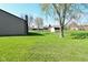 Green backyard featuring well-maintained grass, shed, and the side of the house with vinyl siding at 2206 Tansel Crossing Cir, Indianapolis, IN 46234