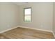 This bright bedroom features modern vinyl flooring, neutral walls, and a double hung window at 2206 Tansel Crossing Cir, Indianapolis, IN 46234
