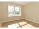 Bright bedroom with modern wood-look flooring and a large window at 2206 Tansel Crossing Cir, Indianapolis, IN 46234