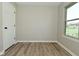This bedroom features wood-look flooring, a door and a window to let the light in at 2206 Tansel Crossing Cir, Indianapolis, IN 46234