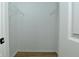 Walk-in closet features modern wood-look flooring and bright lighting at 2206 Tansel Crossing Cir, Indianapolis, IN 46234