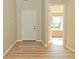 Spacious entryway with wood flooring and natural light, showcasing the home's interior at 2206 Tansel Crossing Cir, Indianapolis, IN 46234