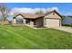 Charming single-story home with well-maintained lawn, attached garage, and inviting curb appeal at 2206 Tansel Crossing Cir, Indianapolis, IN 46234