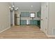 Charming kitchen featuring modern appliances and beautiful blue-green cabinetry at 2206 Tansel Crossing Cir, Indianapolis, IN 46234