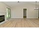 Bright, open-concept living area with fireplace, wood floors, and access to outdoor space at 2206 Tansel Crossing Cir, Indianapolis, IN 46234