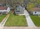 Aerial view of a well-maintained home with lush green lawn and gravel driveway at 2249 N Centennial St, Indianapolis, IN 46222