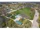 An aerial view shows a lush green park with playground in a neighborhood with mature trees and single-Gathering homes at 2249 N Centennial St, Indianapolis, IN 46222