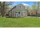Charming two-story home with blue front door, manicured lawn and gravel driveway at 2249 N Centennial St, Indianapolis, IN 46222