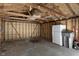Inside of a garage with exposed wood beams and a refrigerator at 2249 N Centennial St, Indianapolis, IN 46222