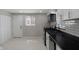 Clean kitchen with white cabinets, modern appliances, subway tile, and neutral tile flooring at 2249 N Centennial St, Indianapolis, IN 46222