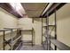 Unfinished basement area with multiple metal storage shelves and painted block walls at 2330 Harlan St, Indianapolis, IN 46203