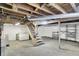Unfinished basement with a wooden staircase leading up, storage shelves, and a laundry area at 2330 Harlan St, Indianapolis, IN 46203