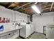 Unfinished basement area featuring laundry hookups, a utility sink, and ample storage space at 2330 Harlan St, Indianapolis, IN 46203