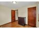 Bedroom featuring hardwood floors, two doors and a chest of drawers at 2330 Harlan St, Indianapolis, IN 46203