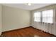 Inviting bedroom showcasing hardwood floors and a window with light-filtering curtains at 2330 Harlan St, Indianapolis, IN 46203