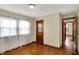 Spacious bedroom with hardwood floors, ample natural light, and access to other rooms at 2330 Harlan St, Indianapolis, IN 46203