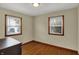 Sunny bedroom with hardwood floors and two windows, offering plenty of natural light at 2330 Harlan St, Indianapolis, IN 46203