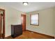 Comfortable bedroom with hardwood floors, featuring a window and a chest of drawers at 2330 Harlan St, Indianapolis, IN 46203