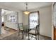 Bright dining area with a glass table and view of the adjacent kitchen area at 2330 Harlan St, Indianapolis, IN 46203