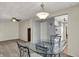 Dining room showcases glass table, overhead light, and view of kitchen through a connecting doorway at 2330 Harlan St, Indianapolis, IN 46203