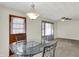Dining room features glass table, metal chairs and windows that bring in sunlight at 2330 Harlan St, Indianapolis, IN 46203