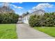 View of one-story home with well-manicured lawn and detached garage at 2330 Harlan St, Indianapolis, IN 46203