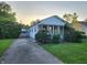 Inviting one-story home with a well-kept front yard, complemented by lush greenery and a paved driveway at 2330 Harlan St, Indianapolis, IN 46203