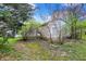 View of detached garage, exterior with surrounding landscape and partial fencing at 2330 Harlan St, Indianapolis, IN 46203