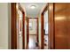 Hallway with wood floors and multiple doors that provide access to other rooms in the house at 2330 Harlan St, Indianapolis, IN 46203