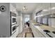 Efficient kitchen featuring white cabinets, vintage oven, stainless sink, and wood-look vinyl floors at 2330 Harlan St, Indianapolis, IN 46203