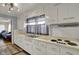 Bright kitchen with white cabinets, a double sink, and laminate countertops beneath a window at 2330 Harlan St, Indianapolis, IN 46203